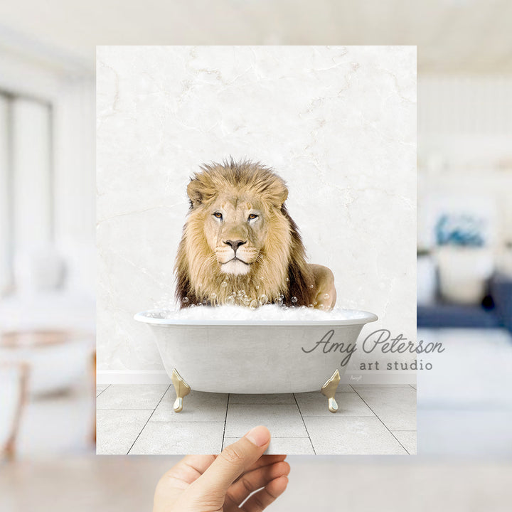 a lion sitting in a bathtub with a hand holding it