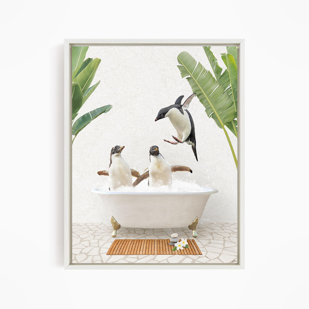 A framed image depicting three penguins sitting in a bathtub, surrounded by tropical plants and a wooden mat on the floor.