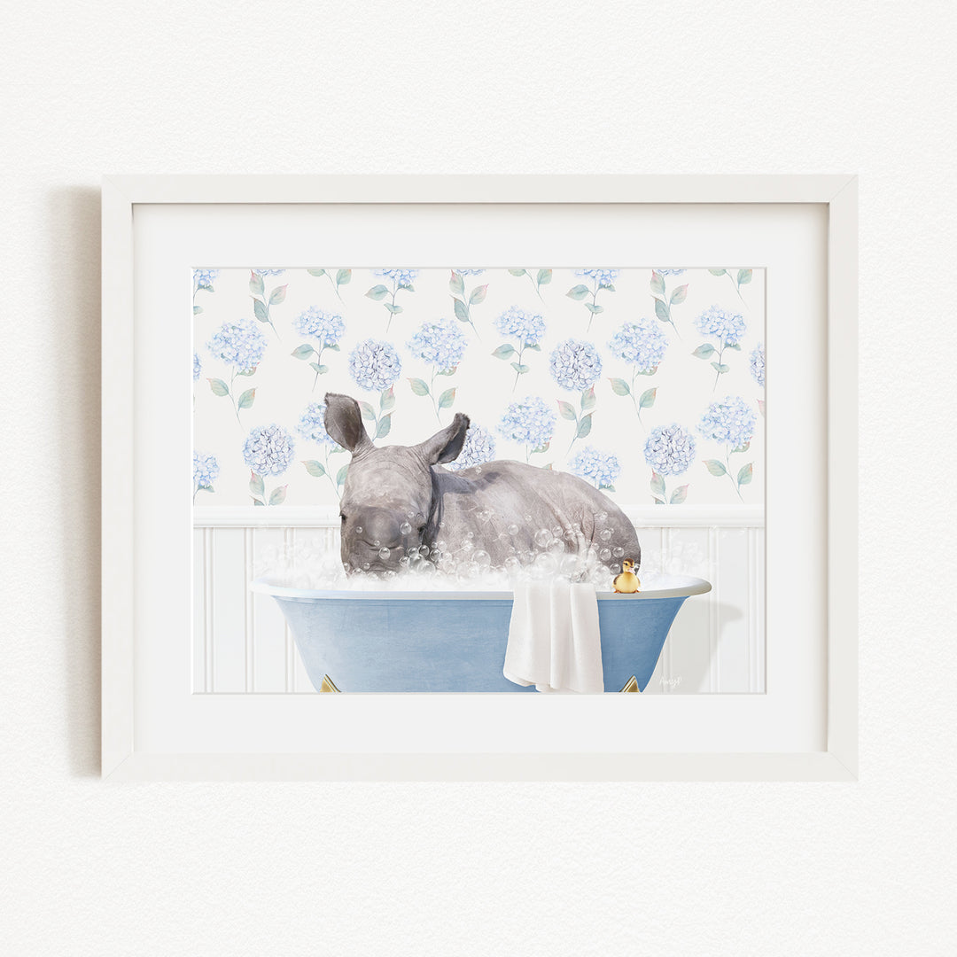 A rhinoceros is sitting in a blue bathtub filled with water, surrounded by a floral pattern on the wall behind it.