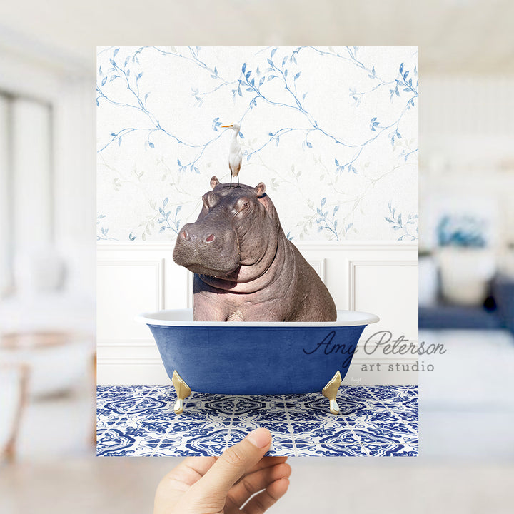 a hippo sitting in a bathtub with a crown on its head