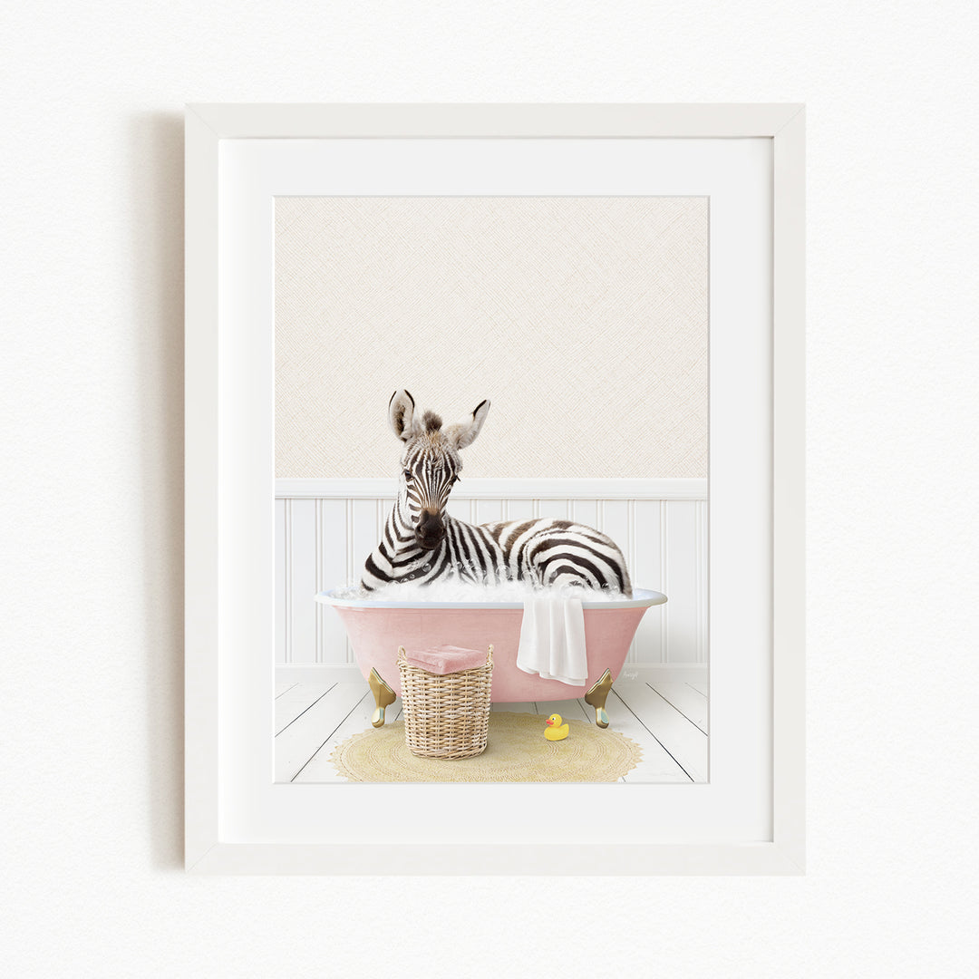 A zebra is sitting in a pink bathtub filled with water, surrounded by rubber ducks.
