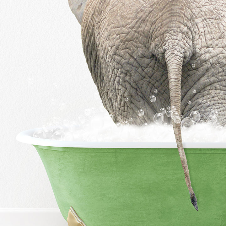 an elephant is taking a bath in a green bathtub