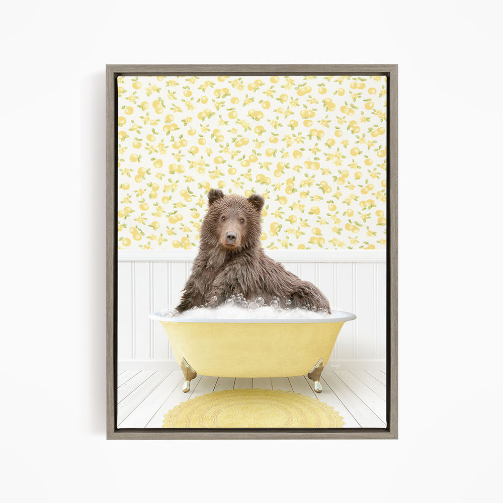 A brown bear sitting in a yellow bathtub filled with bubbles, surrounded by a yellow floral wallpaper.