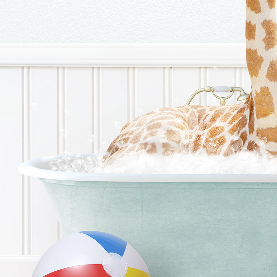 a giraffe laying in a bathtub with a beach ball