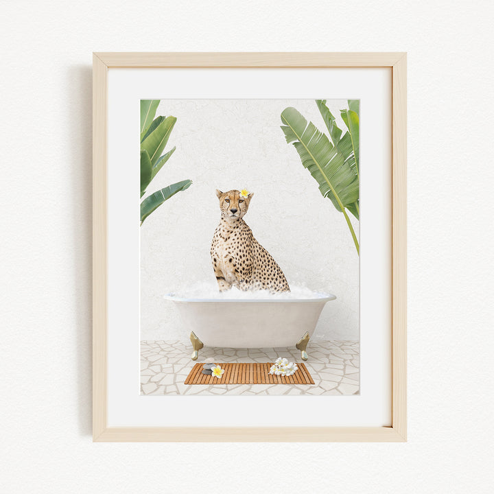 A cheetah sitting in a bathtub filled with water, surrounded by tropical plants.