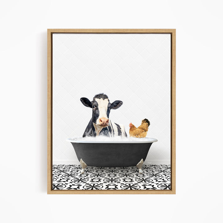 A black and white cow is sitting in a bathtub filled with water, with a chicken standing nearby.