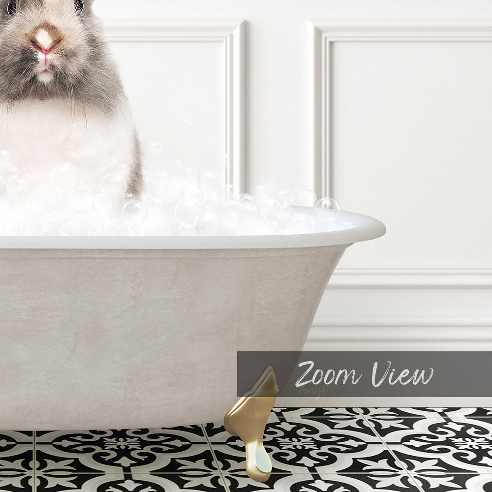 A fluffy white rabbit sitting in a white bathtub filled with bubbles, with a black and white patterned floor in the foreground.