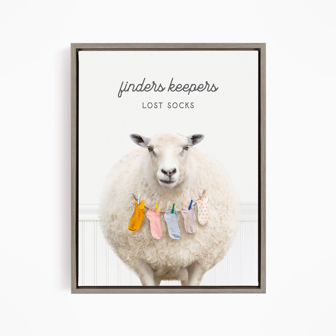 A white sheep with a pile of colorful socks hanging from a clothesline in front of it.