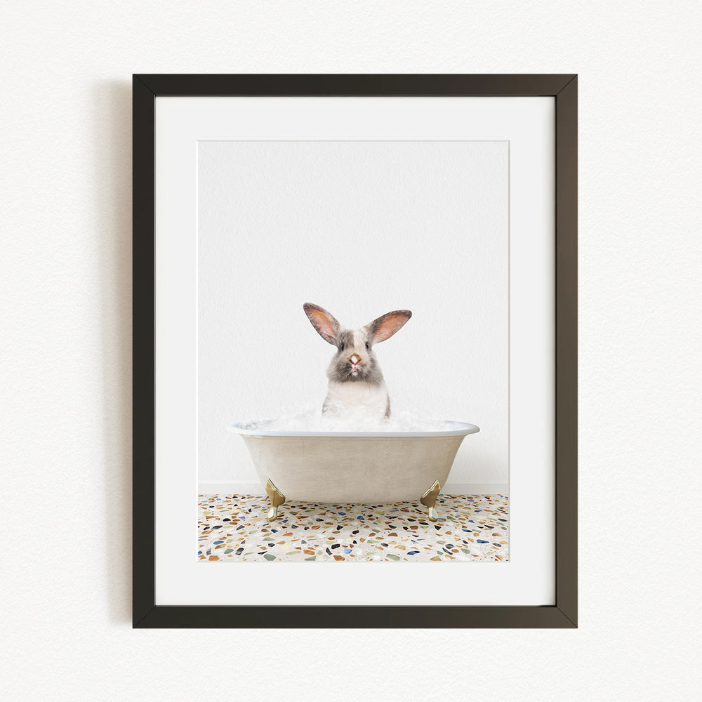 A white rabbit sitting in a white bathtub filled with water, with its head above the water's surface.
