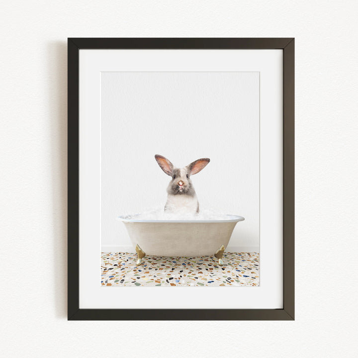 A white rabbit sitting in a white bathtub filled with water, with its head above the water's surface.