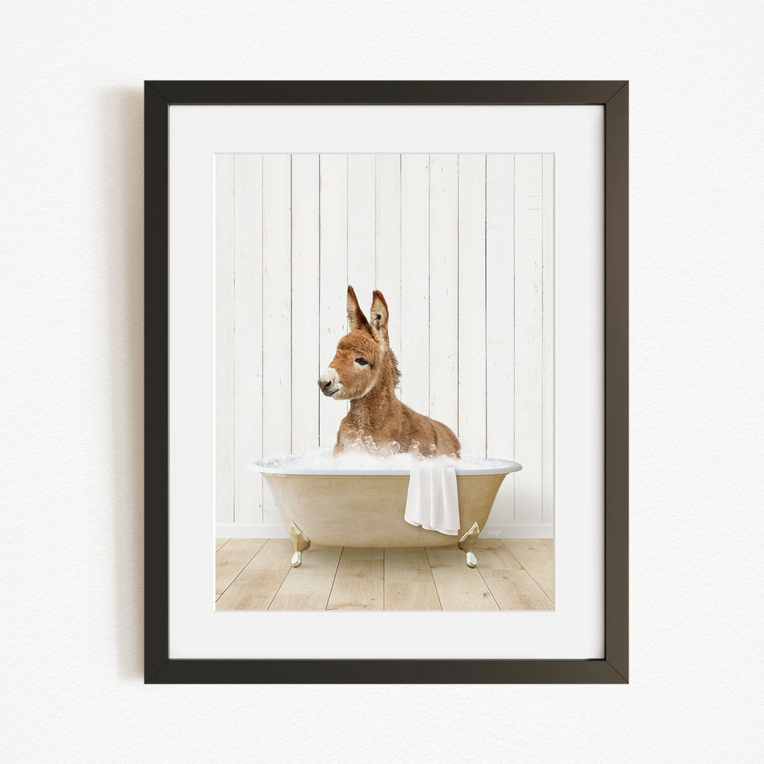 A donkey is sitting in a bathtub filled with water, creating a playful and whimsical scene.