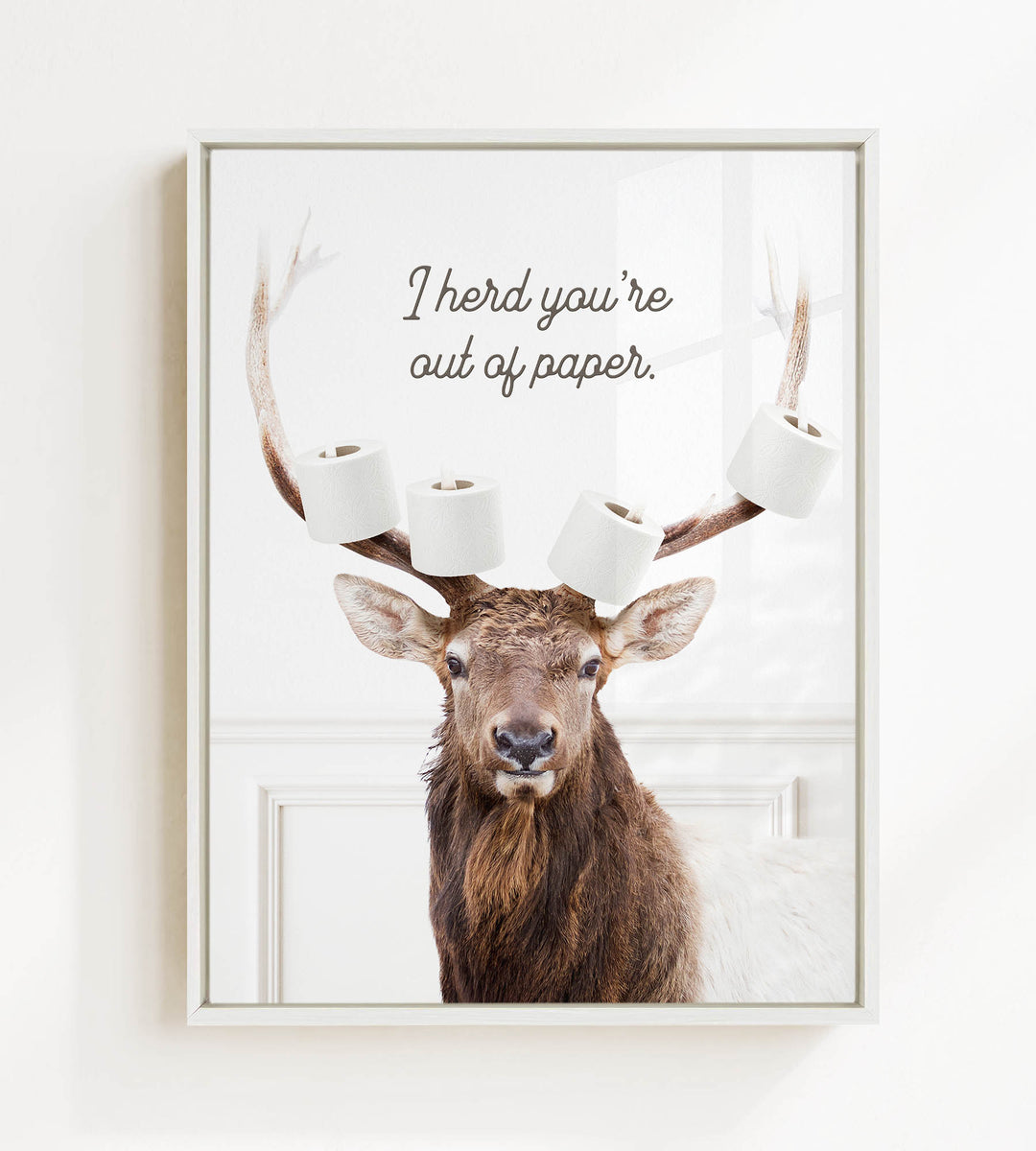 A deer with antlers holding multiple rolls of toilet paper, with the text "I herd you're out of paper" above it.