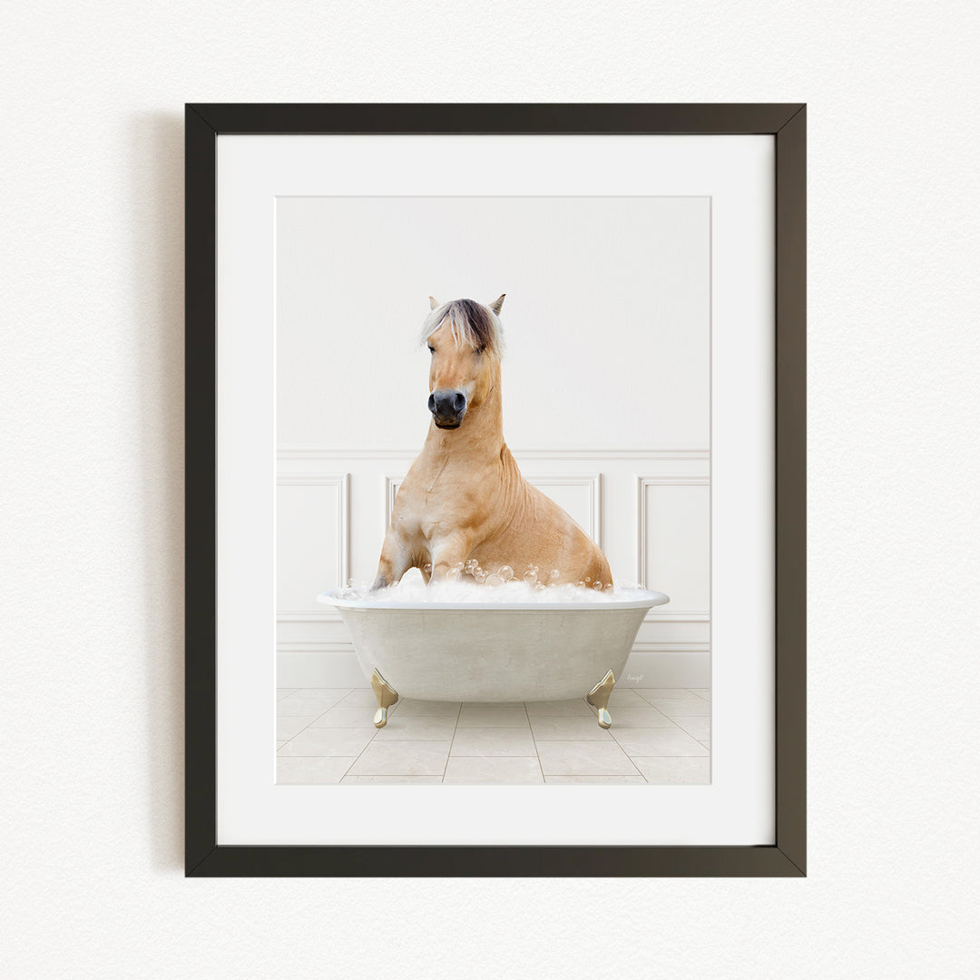 A light brown horse is sitting in a white bathtub filled with bubbles, creating a whimsical and playful scene.