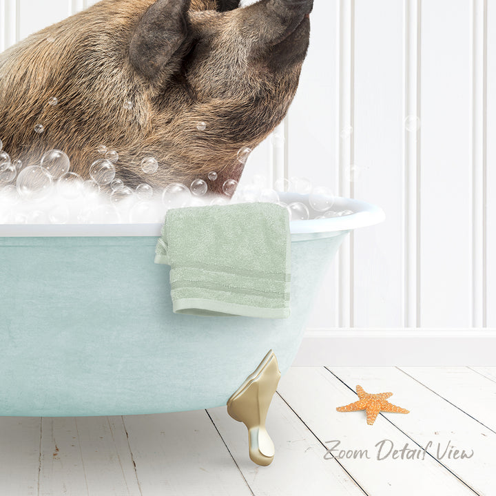A dog is sitting in a bathtub filled with bubbles, with a towel and starfish nearby.