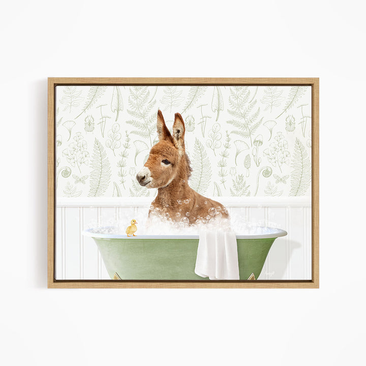 A brown donkey is sitting in a green bathtub filled with bubbles, with a yellow duck nearby.