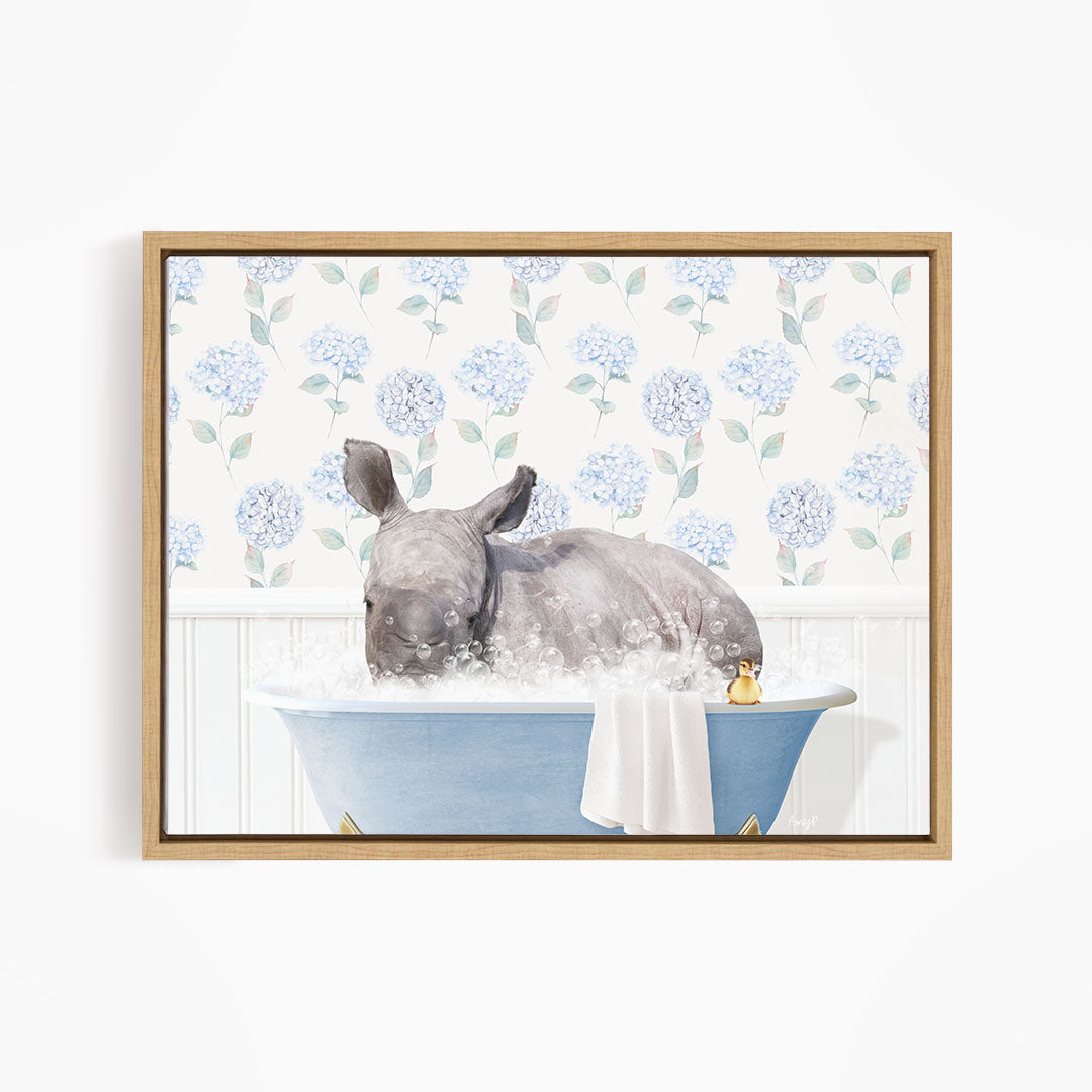A rhinoceros is sitting in a blue bathtub filled with water, surrounded by blue flowers on the wall behind it.