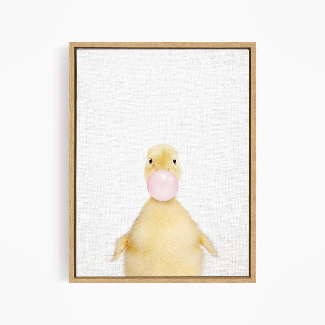 A cute yellow duck blowing a bubble with a pink bubble gum bubble.