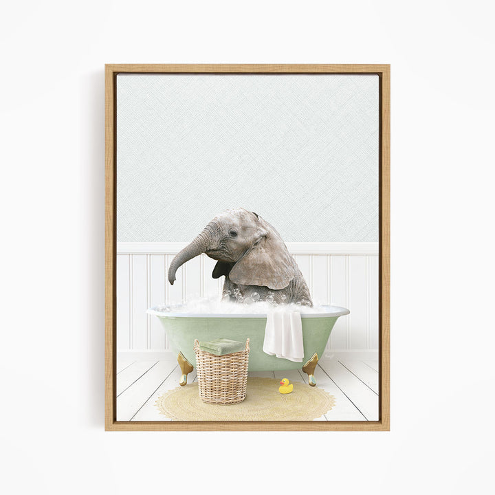 A baby elephant sitting in a green bathtub filled with water, surrounded by a basket of toys and a yellow rubber ducky.