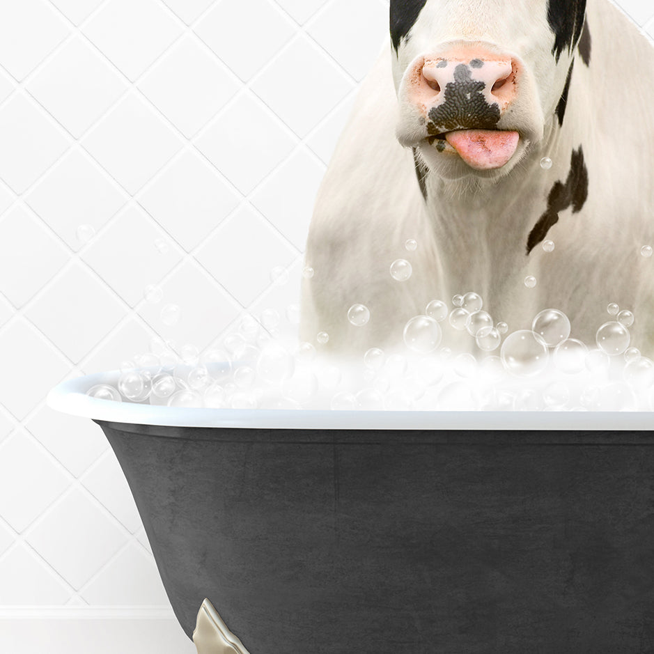 a cow sticking its tongue out in a bathtub filled with bubbles