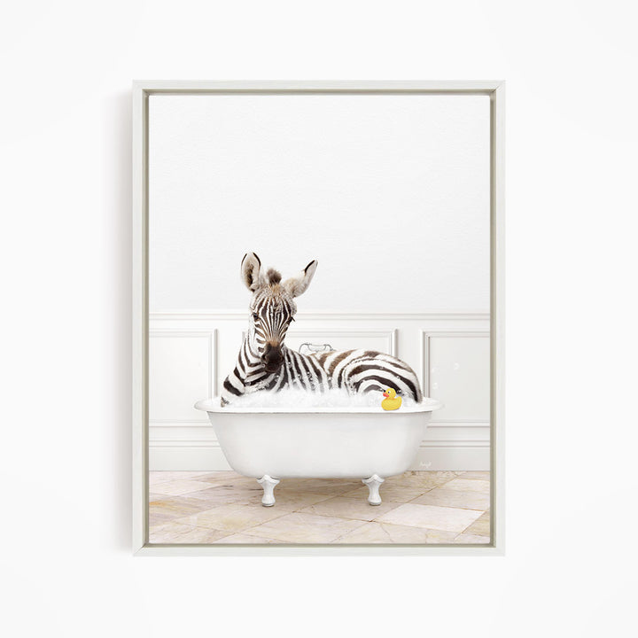 A zebra is sitting in a white bathtub, surrounded by a yellow rubber duck.