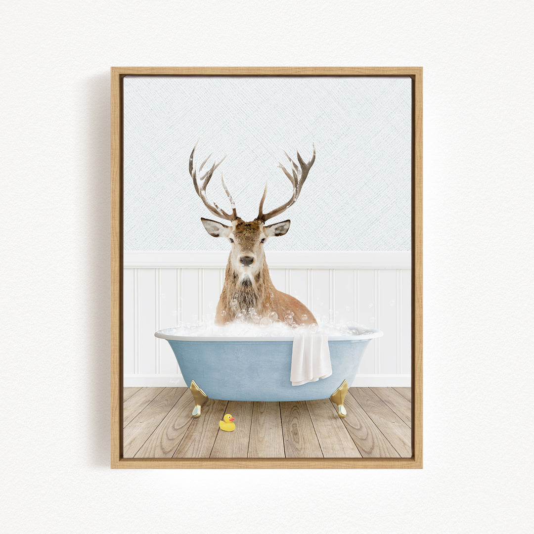 A deer with antlers is sitting in a blue bathtub filled with water, surrounded by a white wall and wooden floor.