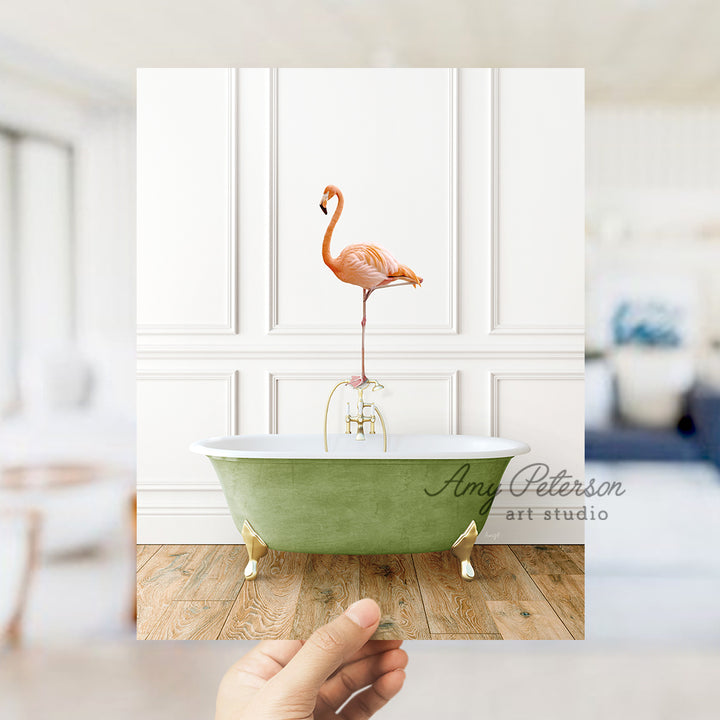 a pink flamingo standing on a green bathtub