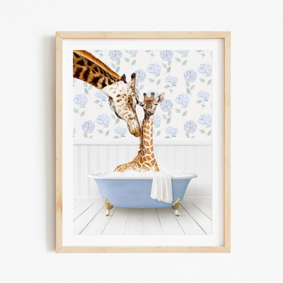 A giraffe and a baby giraffe are sitting in a blue bathtub, with the baby giraffe being bathed by the adult giraffe.