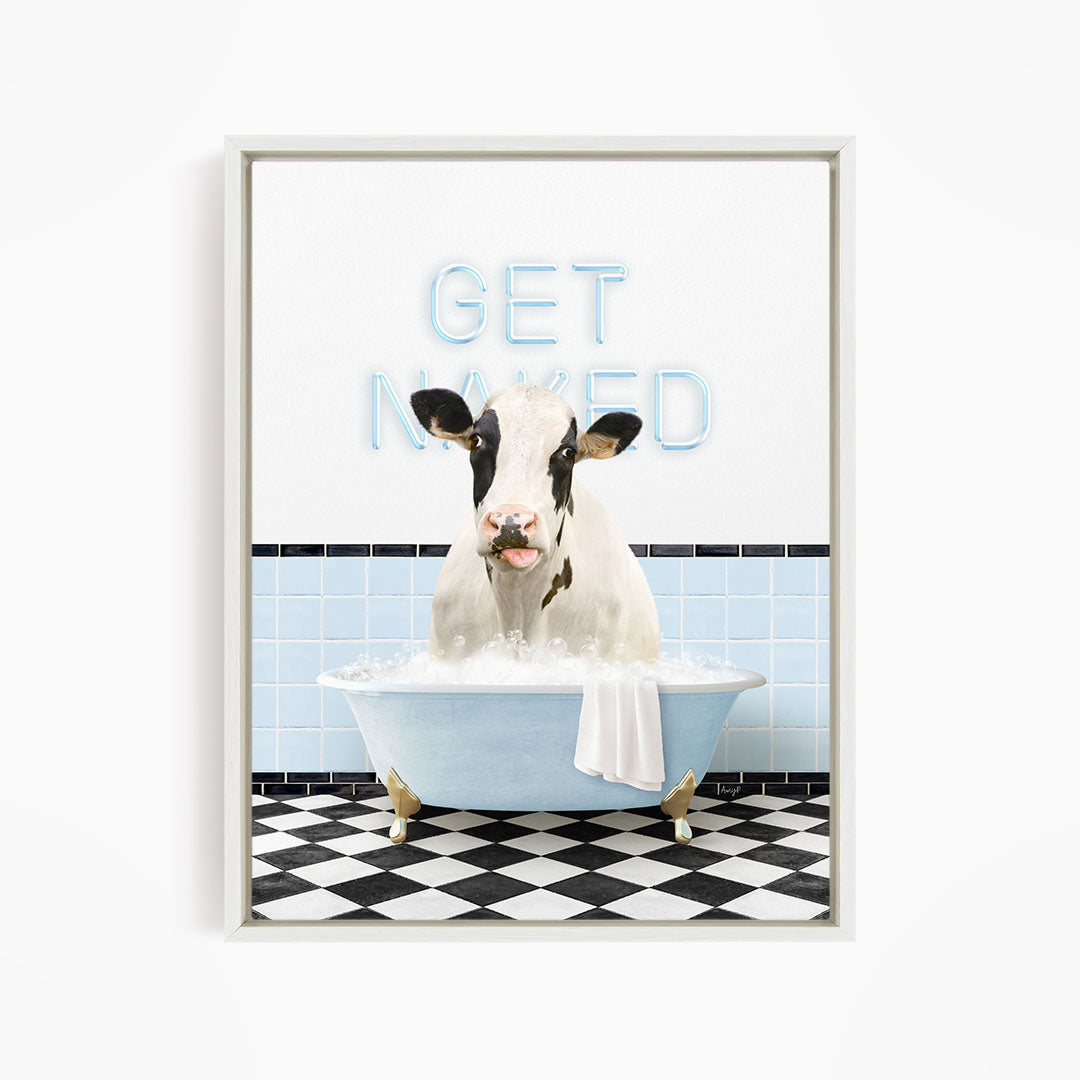 A cow sitting in a bathtub with the words "GET NAKED" written on the wall behind it.
