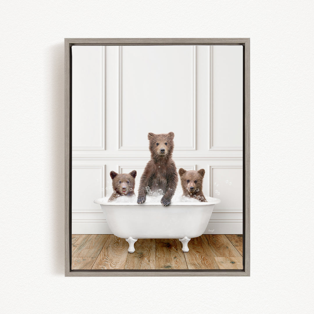 A framed image showing three bears sitting in a white bathtub, with one bear sitting in the center and the other two bears sitting on either side.