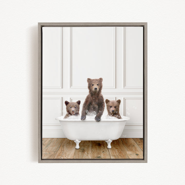 A framed image showing three bears sitting in a white bathtub, with one bear sitting in the center and the other two bears sitting on either side.