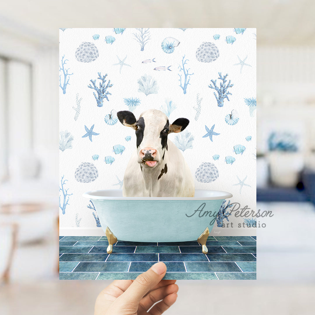 a hand holding up a card with a picture of a cow in a bathtub