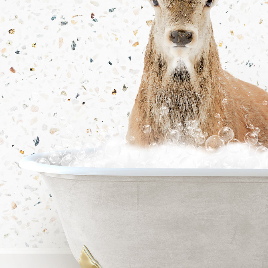 a deer is sitting in a bathtub with bubbles