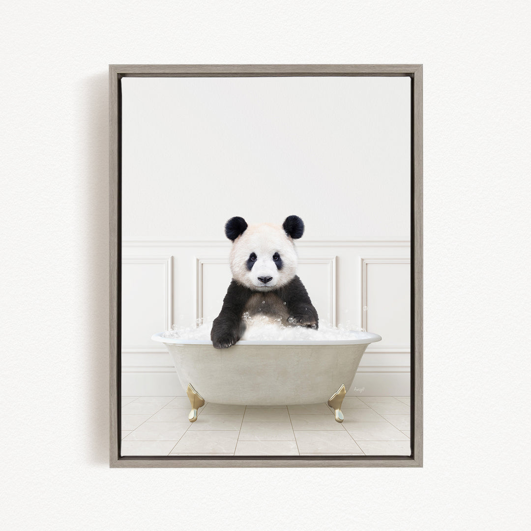 A panda bear sitting in a white bathtub filled with bubbles, looking directly at the camera.