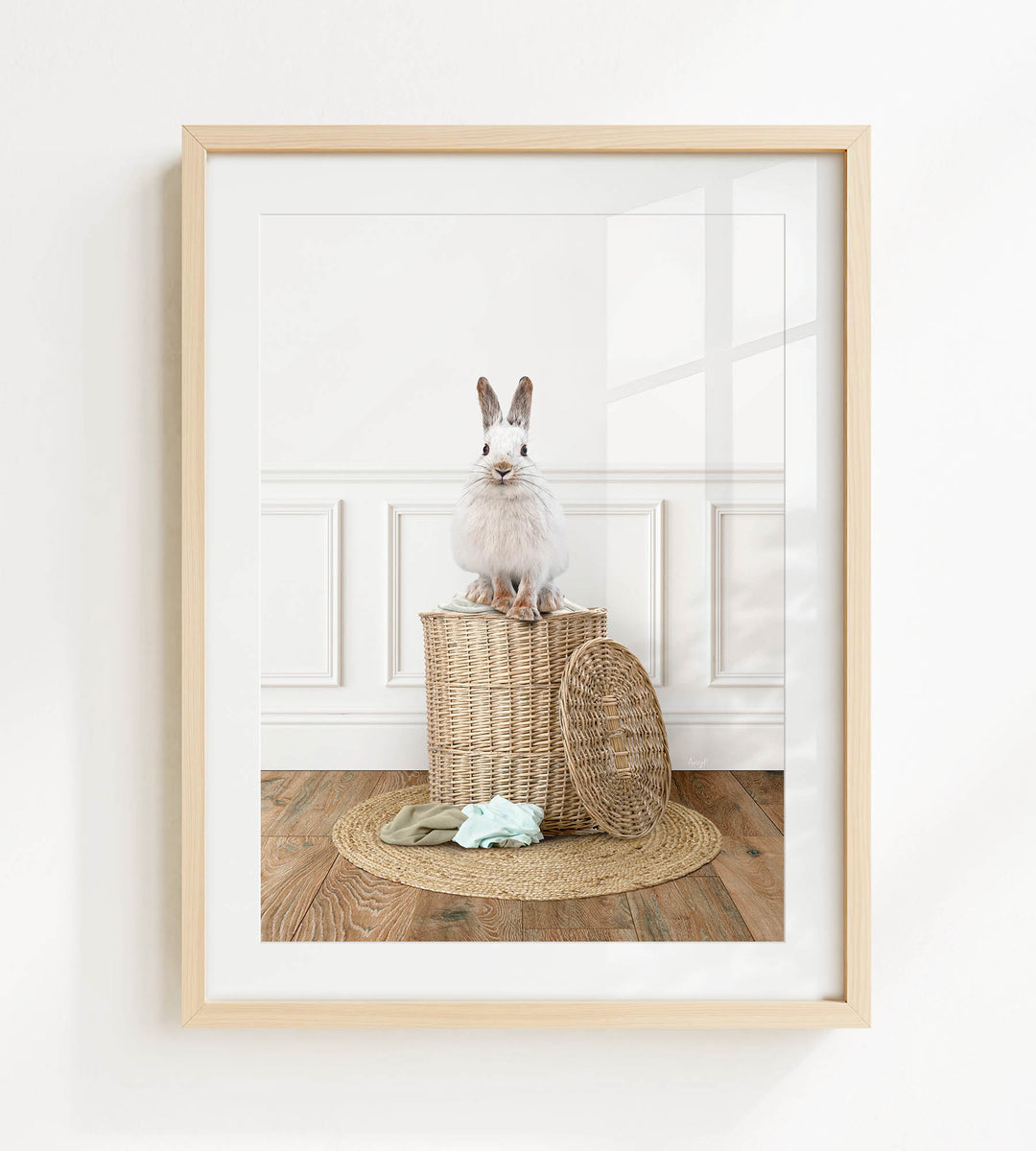 A white rabbit sits atop a wicker basket on a wooden floor, with a woven basket lid nearby.