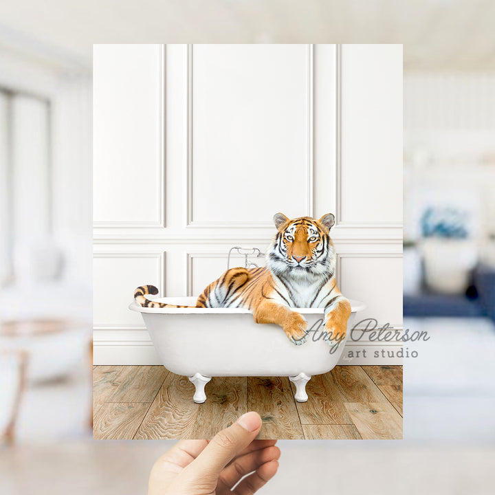 a hand holding a photo of a tiger in a bathtub