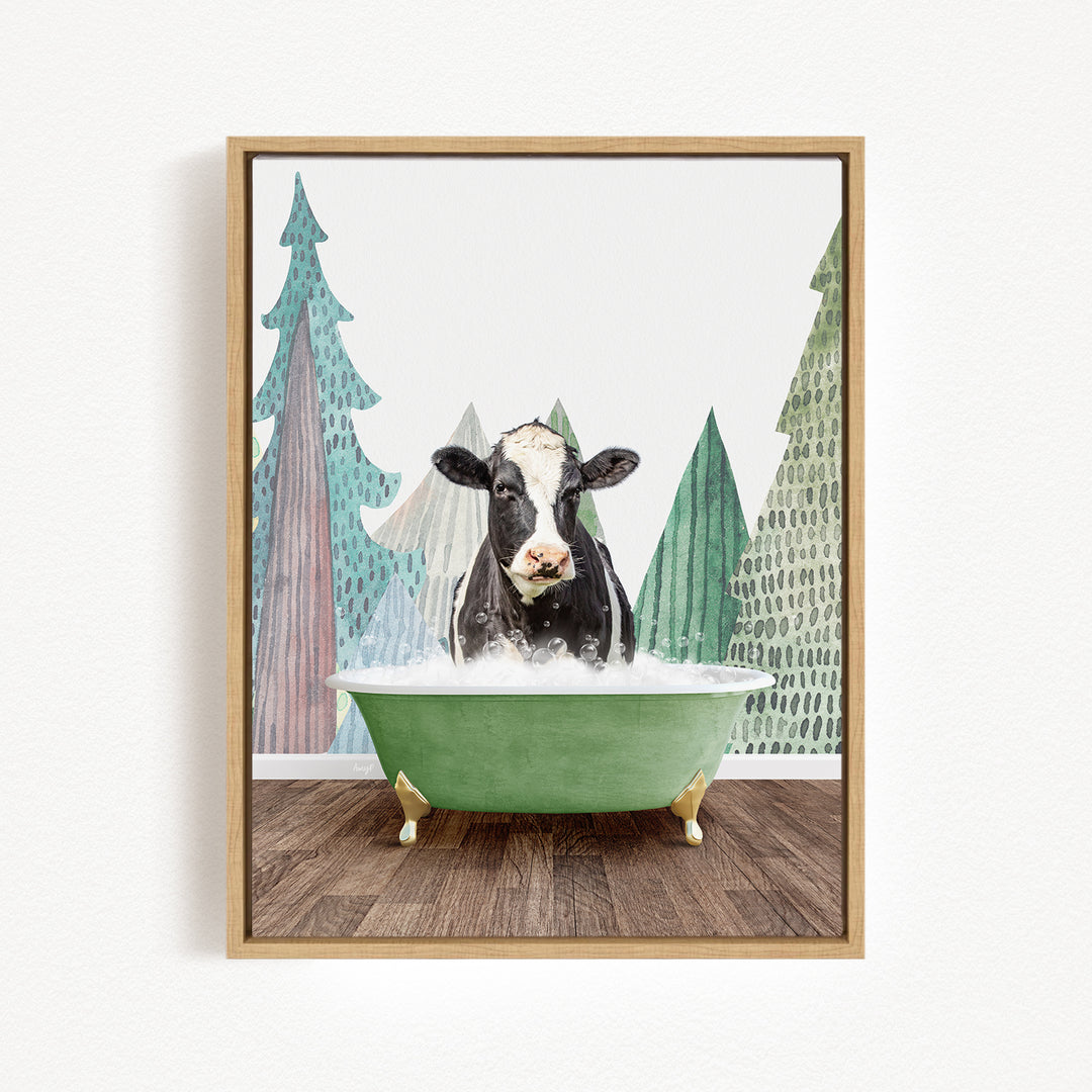 A black and white cow is sitting in a green bathtub, surrounded by a forest-themed background with trees and a snowy landscape.