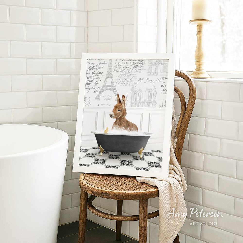 A framed image of a dog sitting in a bathtub, surrounded by a tiled bathroom setting.