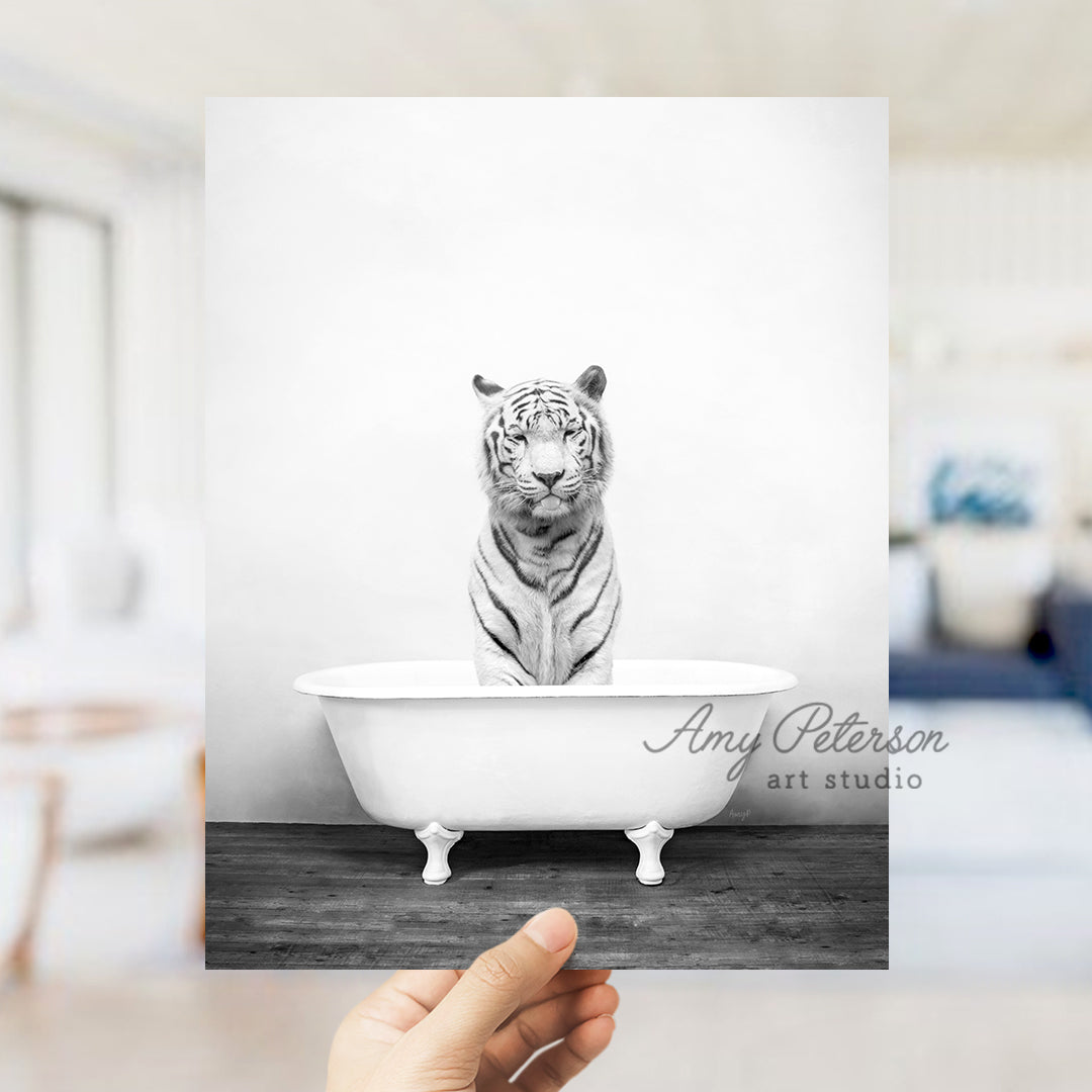 a hand holding a card with a picture of a tiger in a bathtub