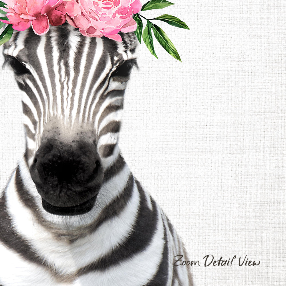 A close-up of a zebra's face with a pink flower crown on its head, set against a plain white background.