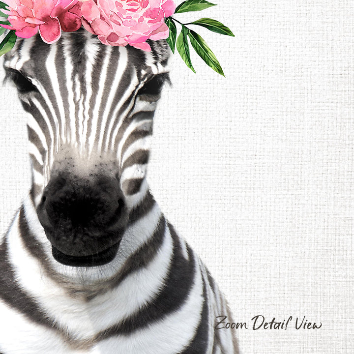 A close-up of a zebra's face with a pink flower crown on its head, set against a plain white background.