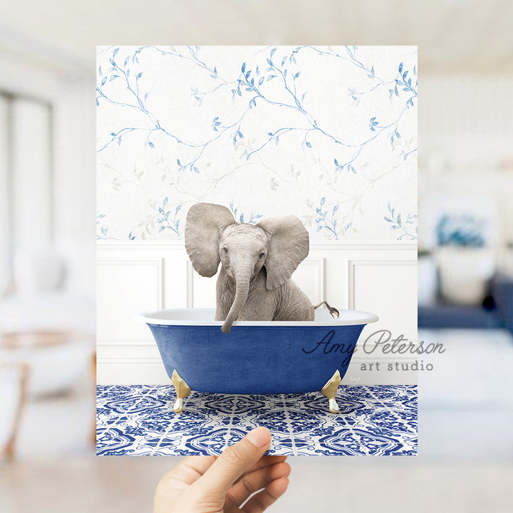 a person holding up a card with an elephant in a bathtub