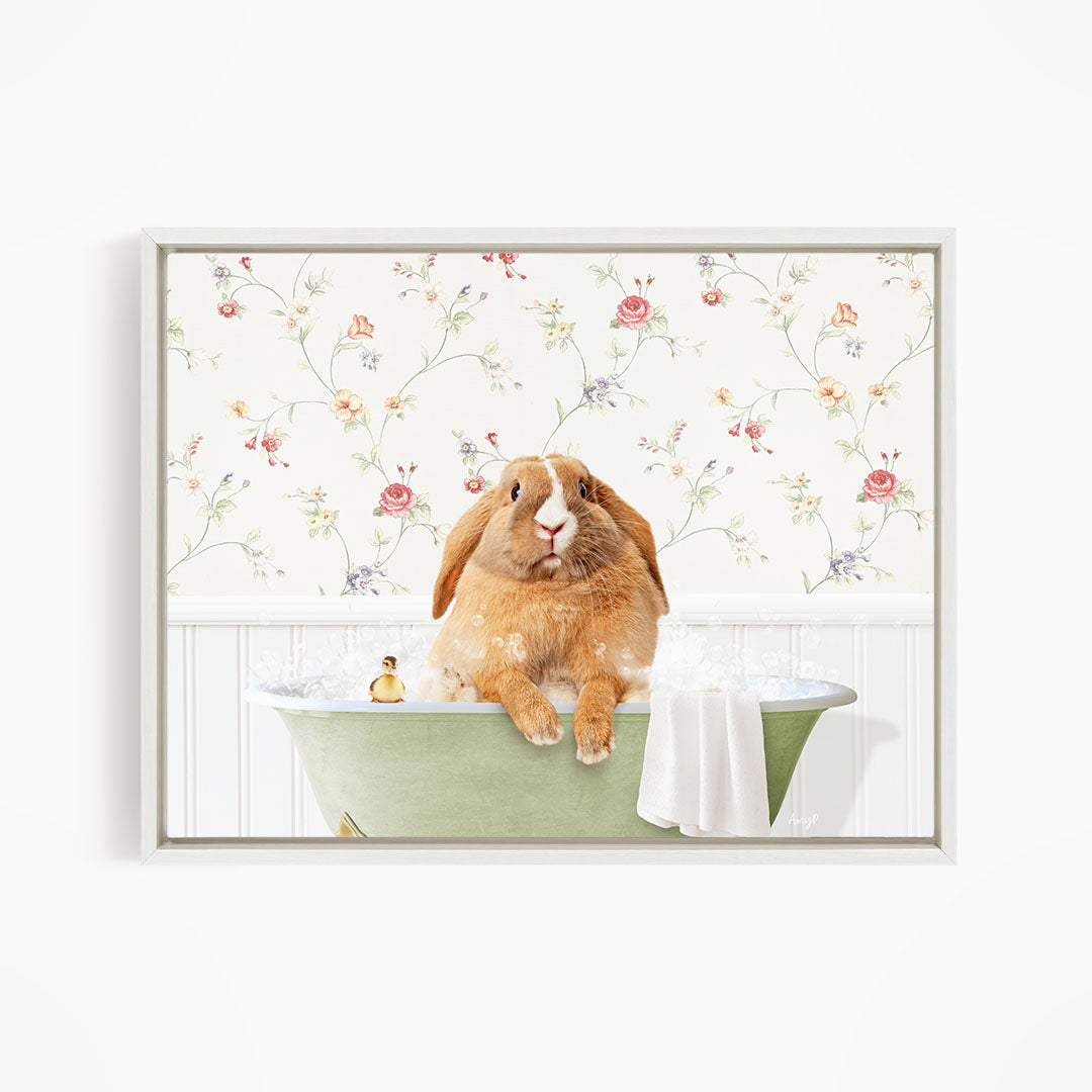 A brown rabbit sitting in a green bathtub filled with water, surrounded by a floral wallpaper.