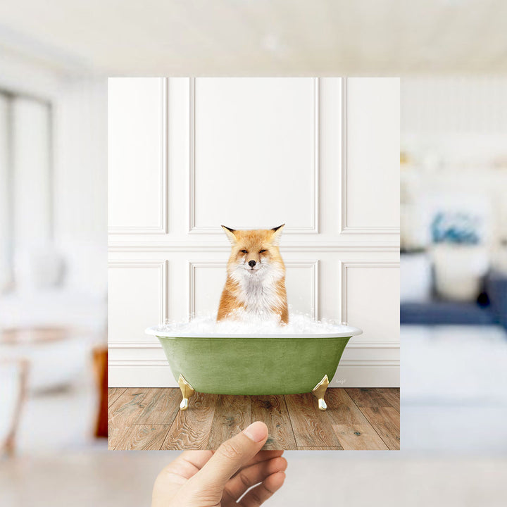 A fox is sitting in a green bathtub filled with bubbles, looking directly at the camera.