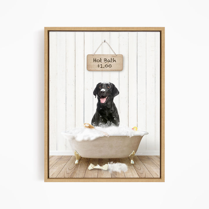 A black dog sitting in a white bathtub filled with bubbles, with a sign above the tub indicating a hot bath for $1.00.