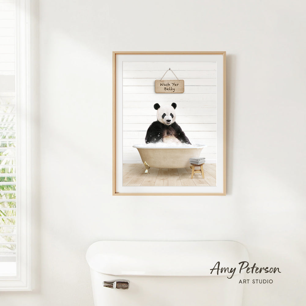 A framed image of a panda sitting in a bathtub, with a sign above it that says "Wash Your Bear".