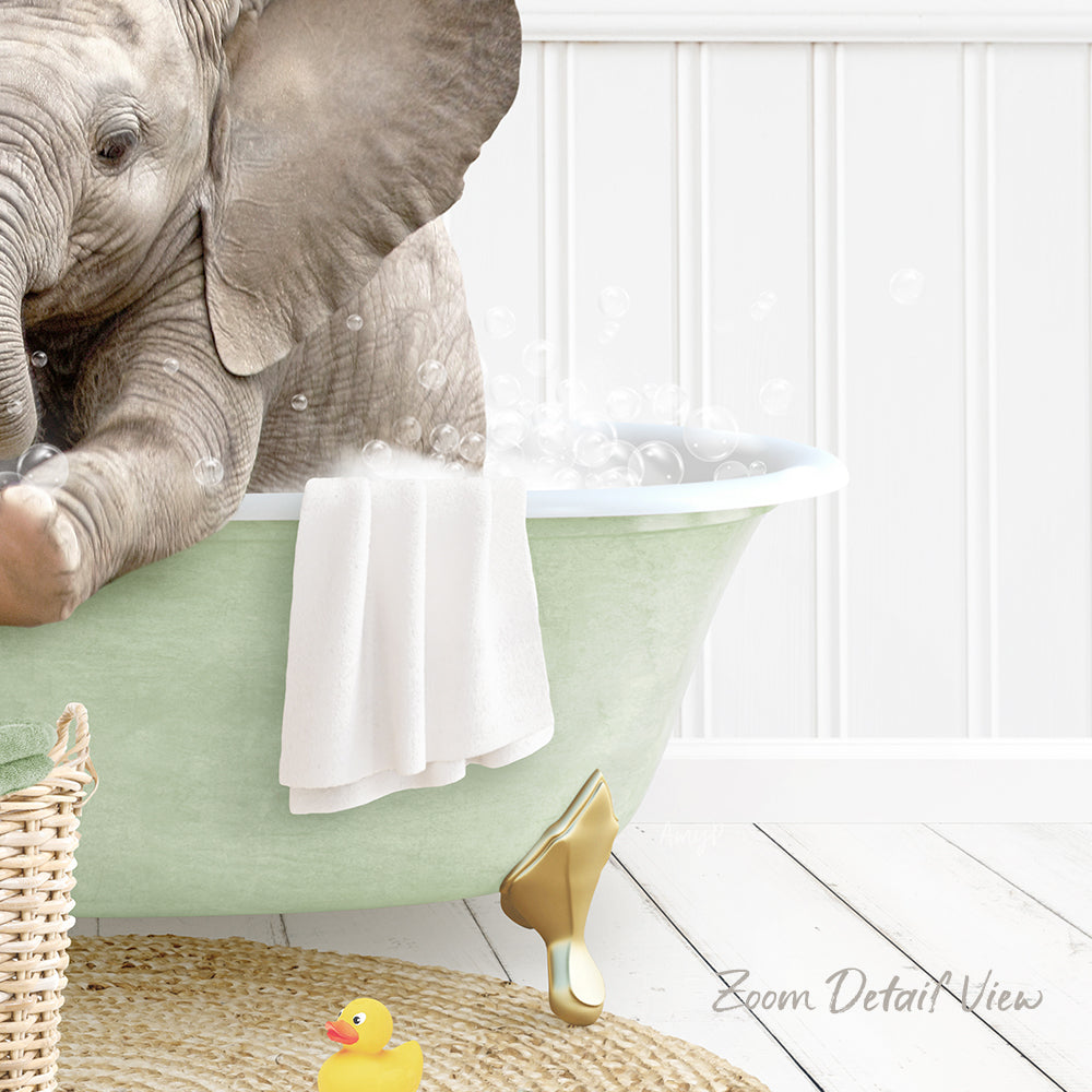 A baby elephant sitting in a green bathtub, surrounded by bubbles and a yellow rubber duck.