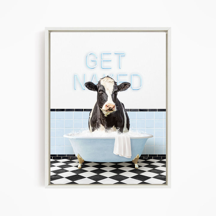 A black and white cow is sitting in a blue bathtub filled with water, with the words "GET NANED" written on the wall behind it.