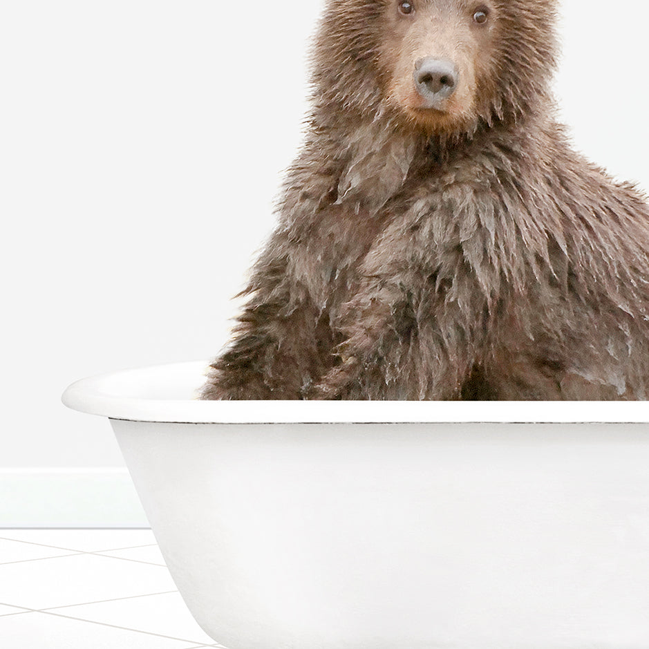 a brown bear sitting in a bath tub