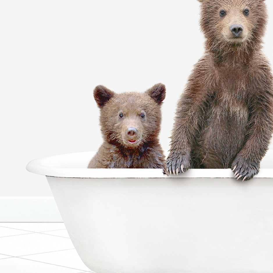 two brown bears are sitting in a bathtub