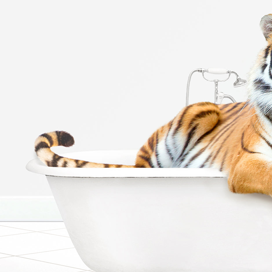 a stuffed tiger is sitting in a bathtub